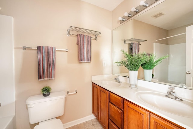 bathroom featuring double vanity, baseboards, visible vents, toilet, and a sink