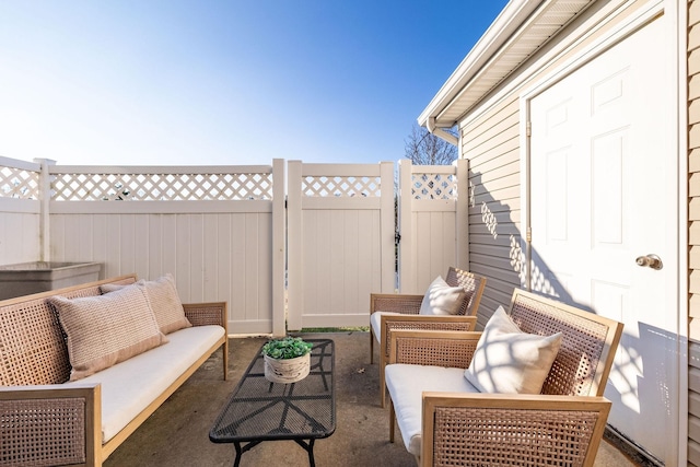 view of patio / terrace featuring a gate, outdoor lounge area, and fence