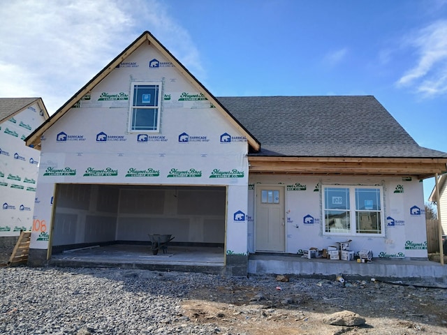 unfinished property featuring roof with shingles