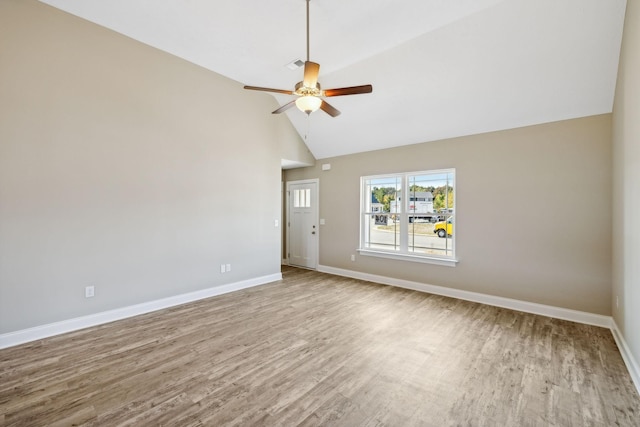 spare room with a ceiling fan, visible vents, baseboards, and wood finished floors