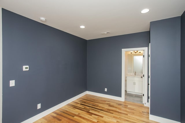 unfurnished room with baseboards, recessed lighting, visible vents, and light wood-style floors