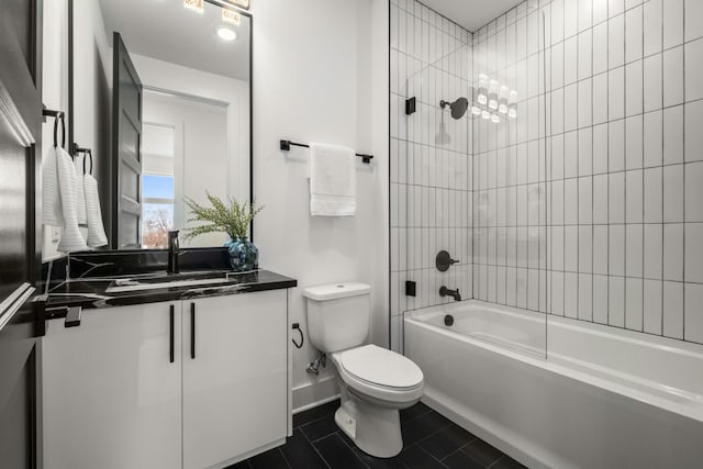 bathroom with baseboards, toilet, tile patterned flooring, vanity, and shower / washtub combination