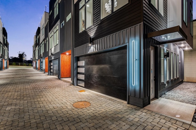 exterior space featuring a garage and brick siding