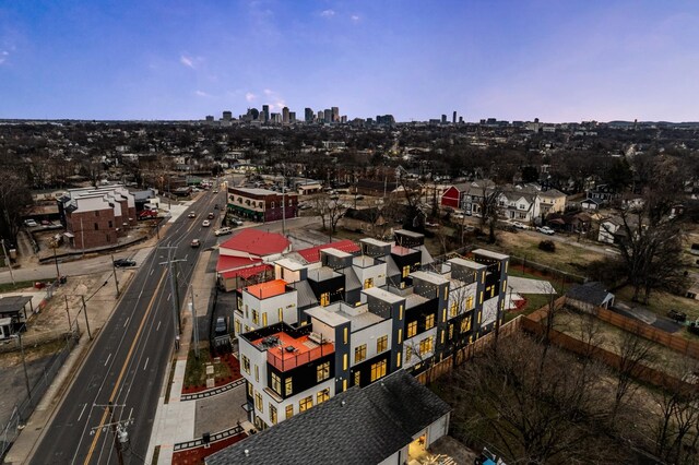 aerial view at dusk featuring a view of city