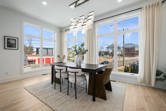 dining room with a healthy amount of sunlight, light wood-style flooring, and recessed lighting