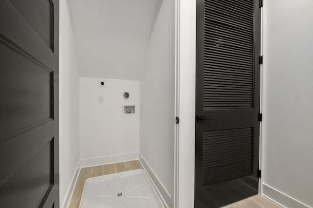 clothes washing area featuring light wood finished floors, laundry area, baseboards, washer hookup, and electric dryer hookup