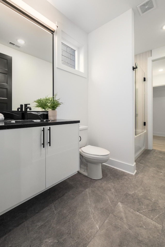 bathroom with toilet, visible vents, bath / shower combo with glass door, and vanity