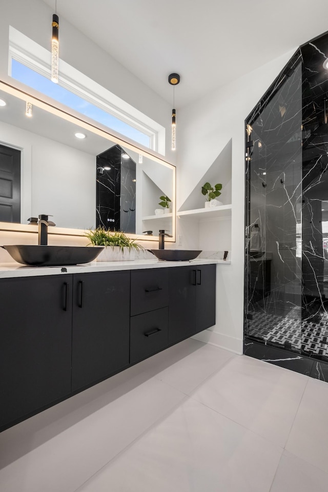 full bath with double vanity, a sink, a marble finish shower, and recessed lighting