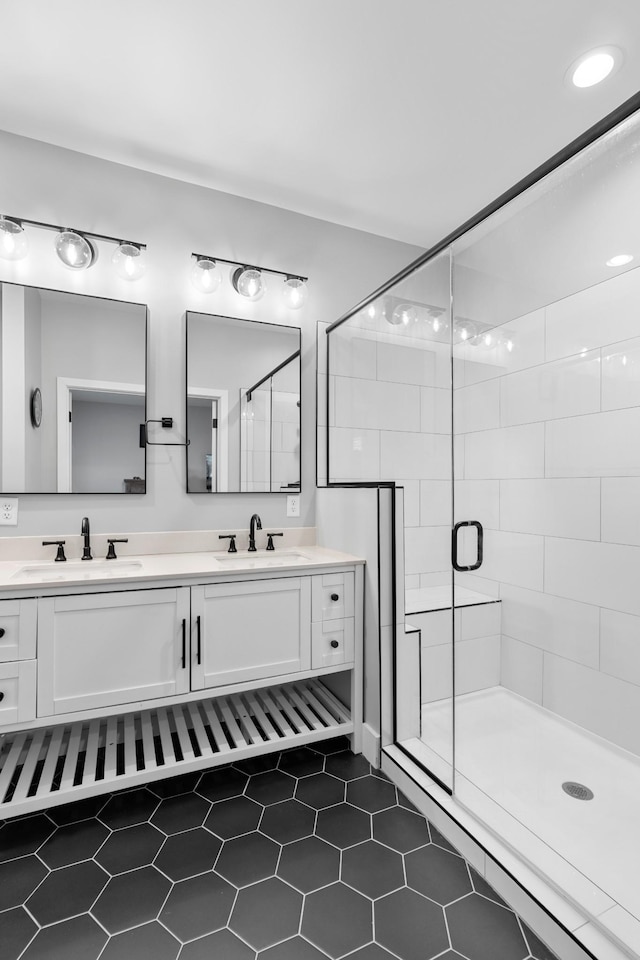 bathroom featuring double vanity, a sink, and a shower stall