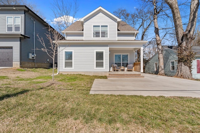 rear view of property with roof with shingles and a yard