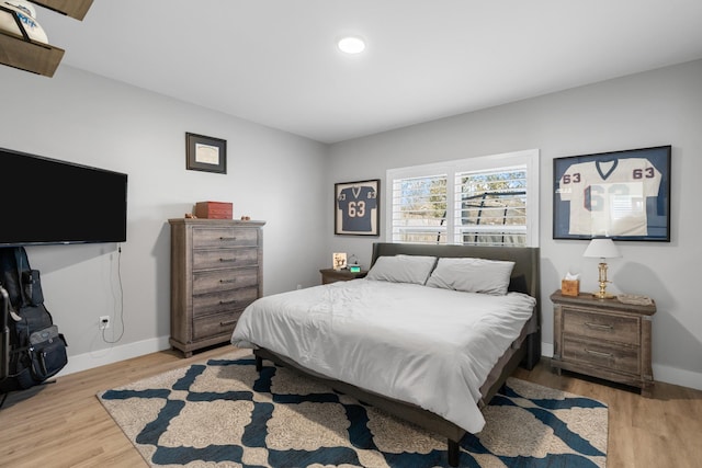 bedroom with light wood-type flooring, baseboards, and recessed lighting