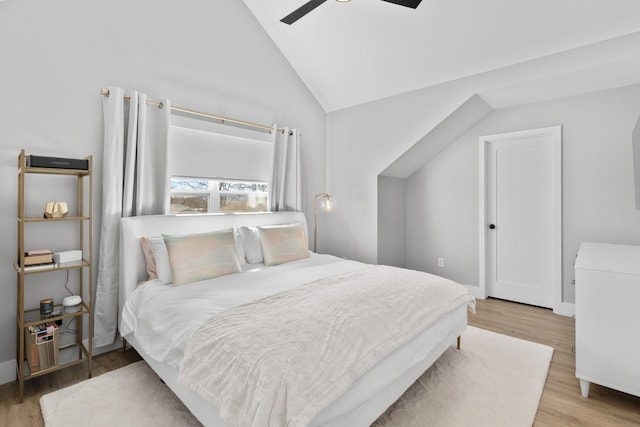 bedroom featuring a ceiling fan, vaulted ceiling, and wood finished floors