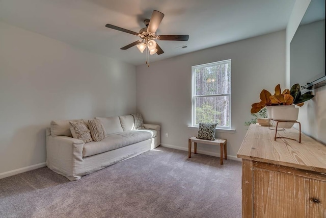 living area with carpet, visible vents, and baseboards