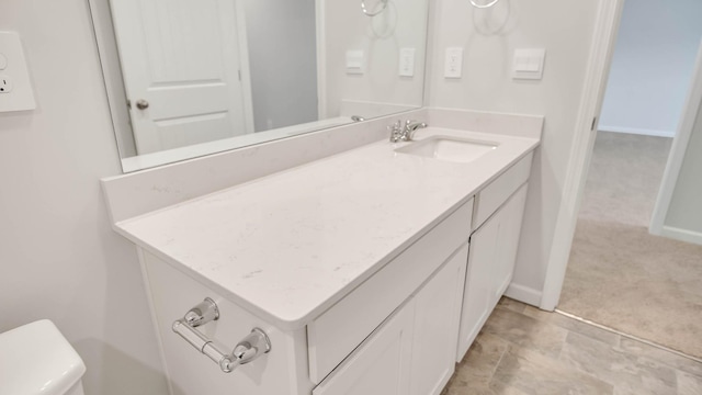 bathroom with vanity and baseboards