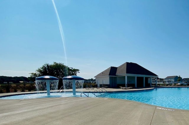 pool featuring a patio area and fence