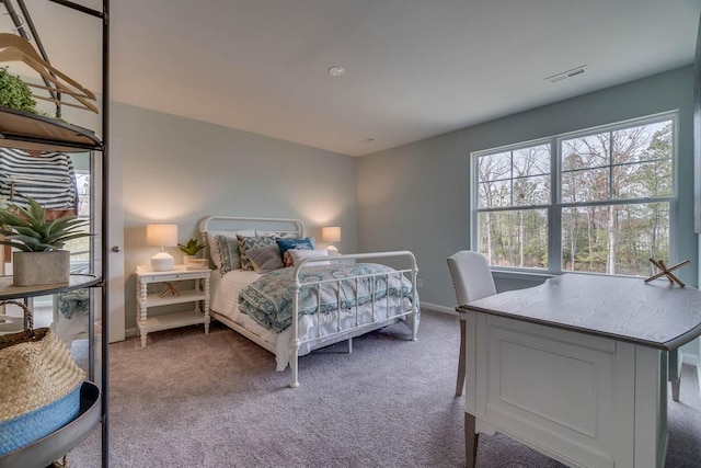 bedroom with carpet, visible vents, and baseboards