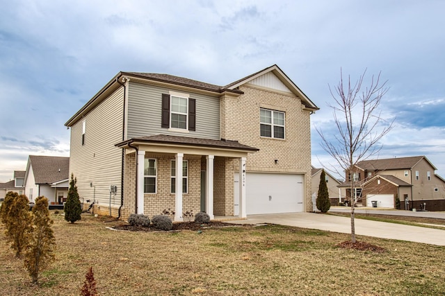 traditional home featuring driveway, a front yard, a garage, and brick siding