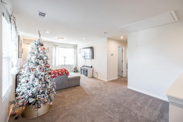 living room with carpet, attic access, visible vents, and baseboards