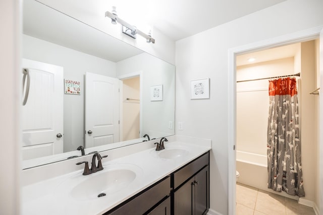 bathroom featuring double vanity, tile patterned flooring, a sink, and shower / bath combo with shower curtain