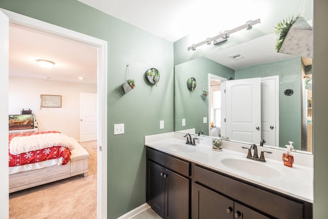 full bath with double vanity, visible vents, a sink, and ensuite bathroom