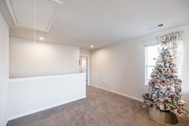 carpeted spare room with attic access, recessed lighting, visible vents, and baseboards