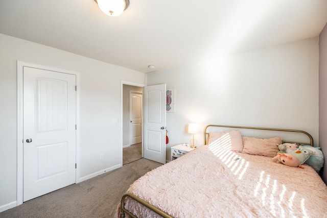 bedroom with light carpet and baseboards