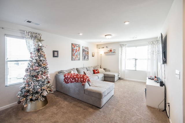 living room featuring light carpet, visible vents, and baseboards