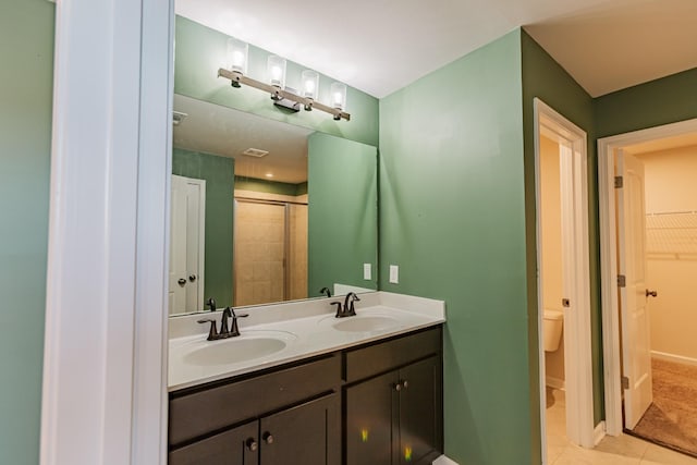 full bath featuring baseboards, a spacious closet, a sink, and tile patterned floors