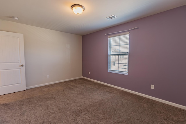 carpeted empty room with visible vents and baseboards