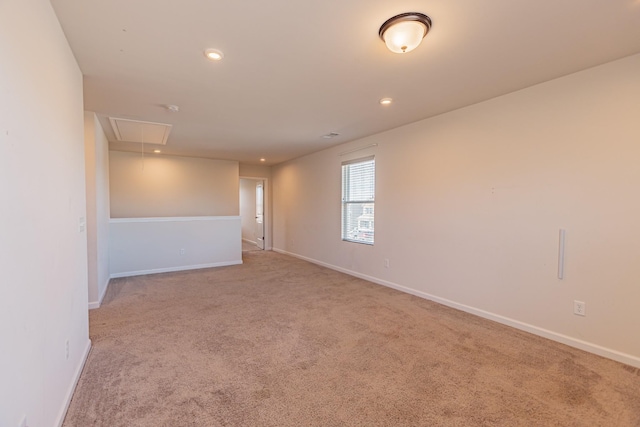 carpeted empty room featuring recessed lighting, attic access, and baseboards