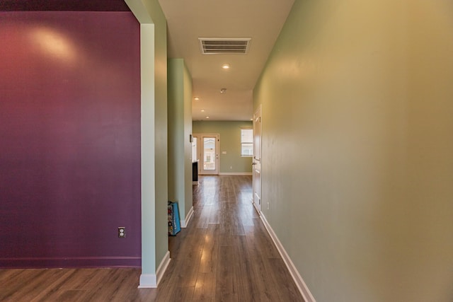 hall with baseboards, visible vents, dark wood finished floors, and recessed lighting