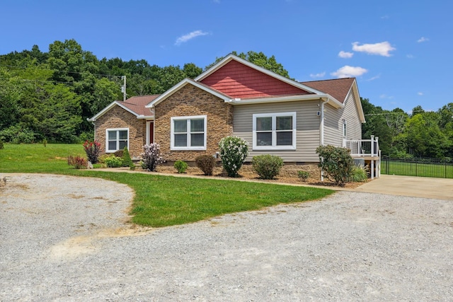 craftsman-style home with crawl space, driveway, a front lawn, and fence