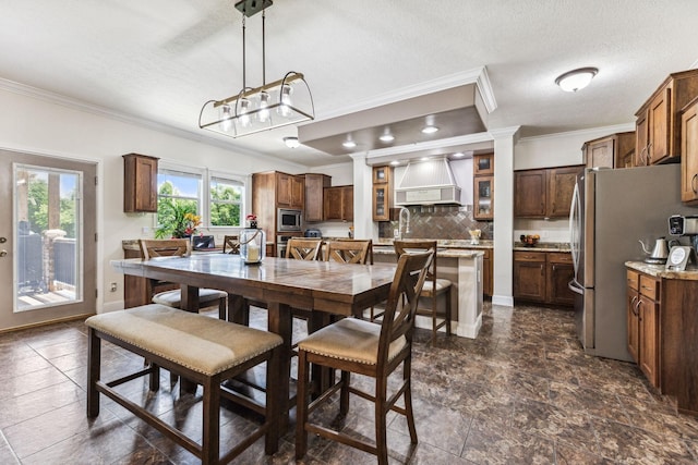 dining room featuring baseboards, ornamental molding, and a textured ceiling