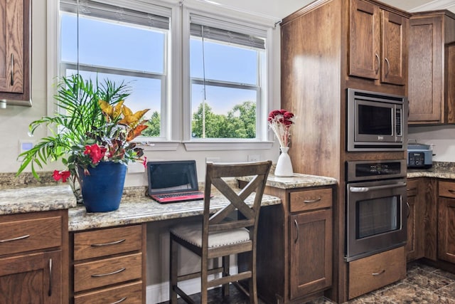 kitchen with light stone countertops and appliances with stainless steel finishes