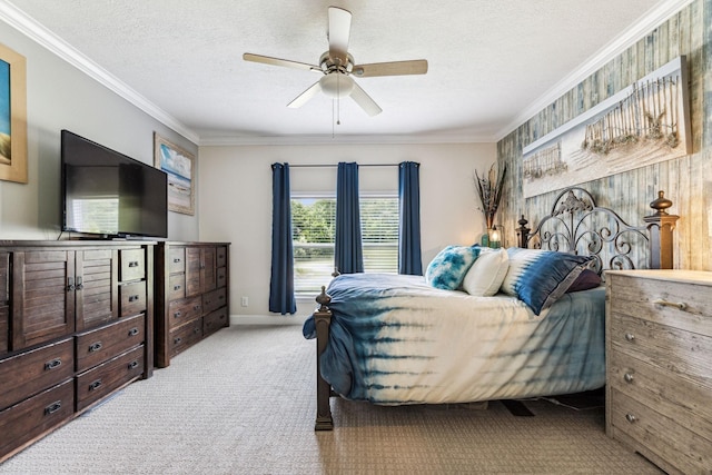 bedroom featuring a textured ceiling, light carpet, a ceiling fan, baseboards, and crown molding