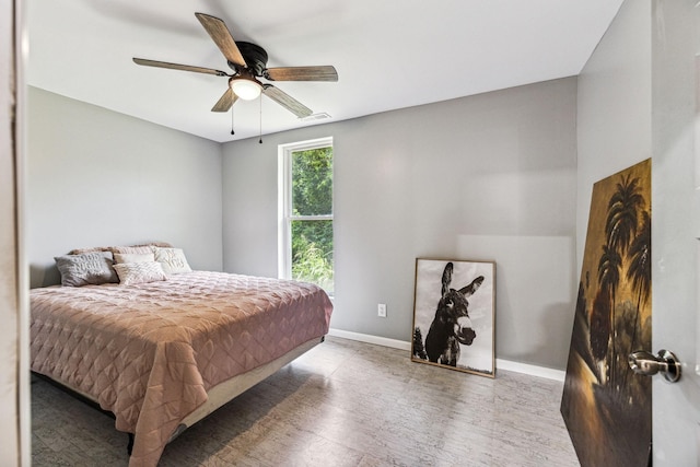 bedroom with baseboards, a ceiling fan, and wood finished floors