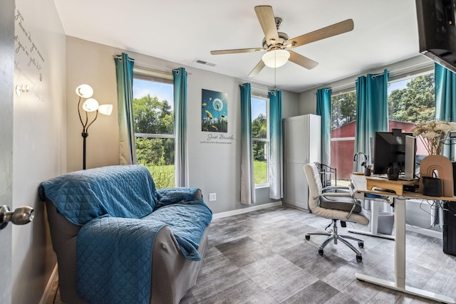 office area featuring ceiling fan, visible vents, and baseboards