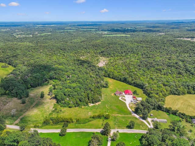 birds eye view of property featuring a view of trees