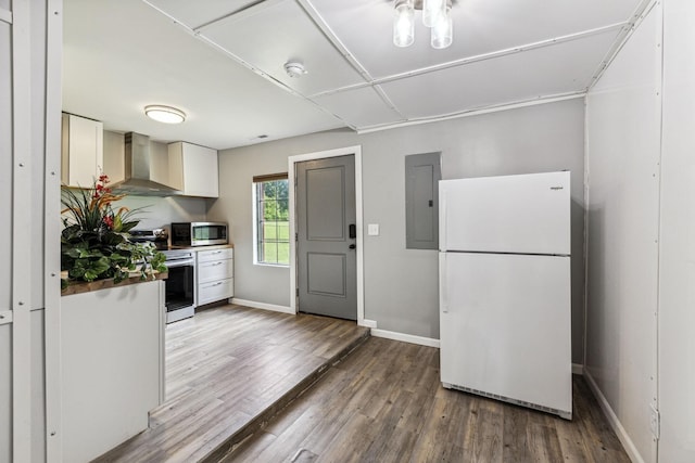 kitchen with appliances with stainless steel finishes, wall chimney range hood, wood finished floors, electric panel, and baseboards