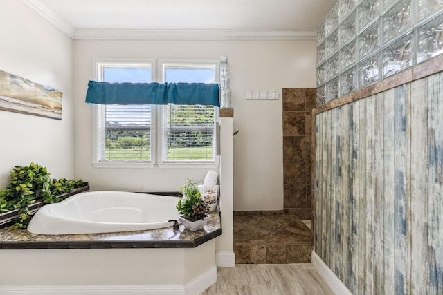 full bath featuring a garden tub, baseboards, a walk in shower, and crown molding