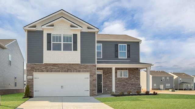 craftsman house featuring an attached garage, concrete driveway, and a front yard