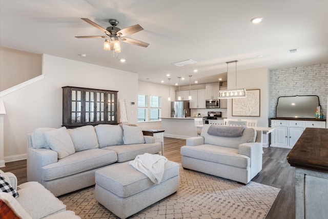 living room featuring recessed lighting, baseboards, and wood finished floors