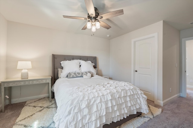 bedroom featuring light colored carpet, ceiling fan, visible vents, and baseboards