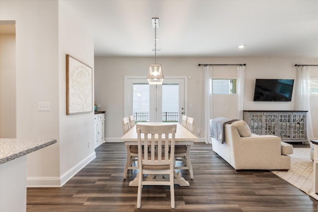 dining space with dark wood-type flooring and baseboards