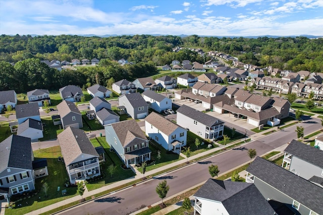 bird's eye view with a wooded view and a residential view