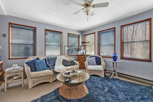 carpeted living area featuring plenty of natural light, ceiling fan, and a textured ceiling