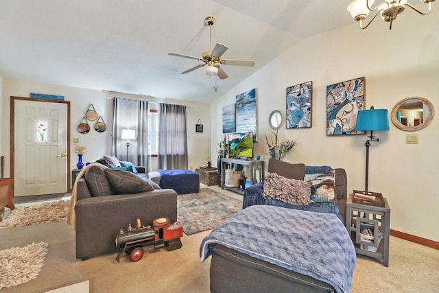 living area with baseboards, ceiling fan with notable chandelier, vaulted ceiling, and light colored carpet