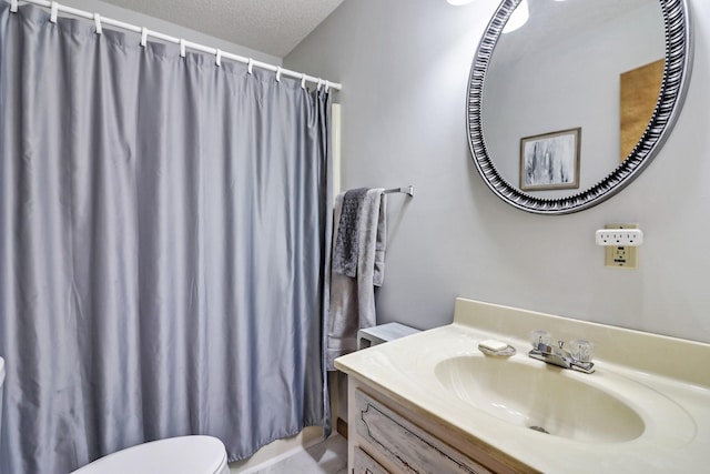 full bath featuring toilet, a textured ceiling, a shower with shower curtain, and vanity