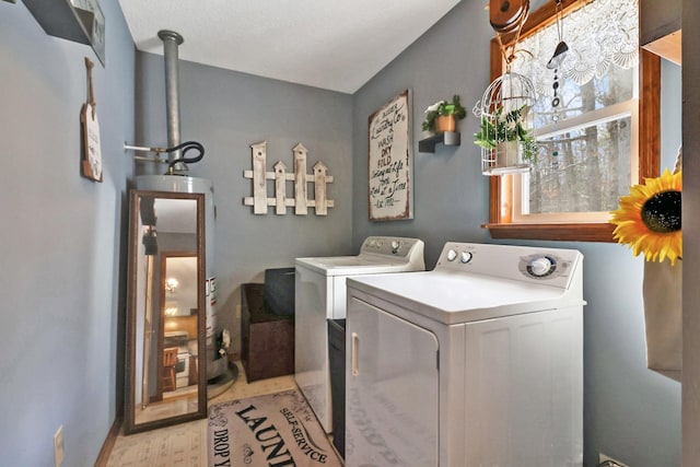 laundry room featuring laundry area, light wood-style flooring, and washer and dryer