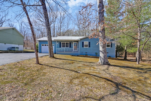 single story home featuring metal roof, aphalt driveway, crawl space, covered porch, and an attached garage